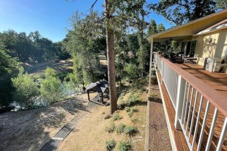 a porch of a house with a bench on it at Creekside Dream Game Room Sleeps 12 bbq near town in Oakhurst