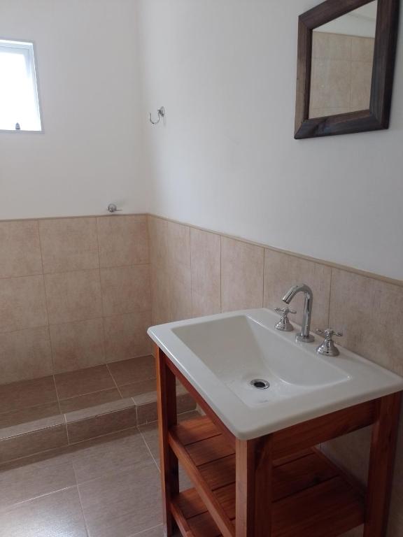 a bathroom with a sink and a mirror at El Destino in San Miguel del Monte