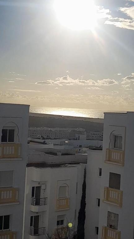 a view of a building with the ocean in the background at RELAX IBN BATOUTA in Tangier
