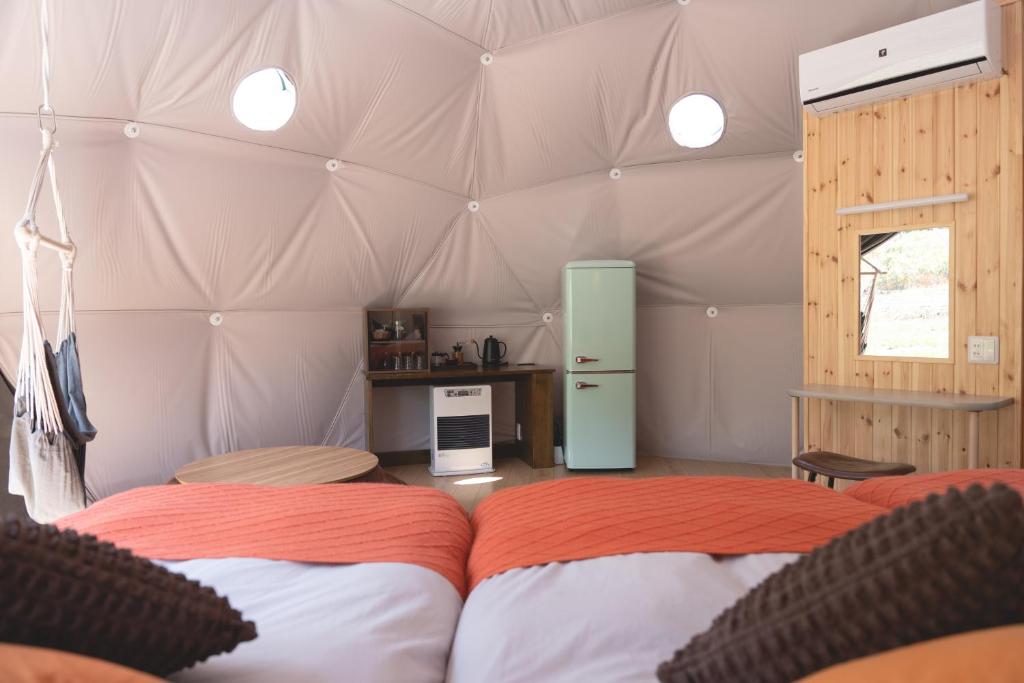 Postel nebo postele na pokoji v ubytování Glamping TOMAMU