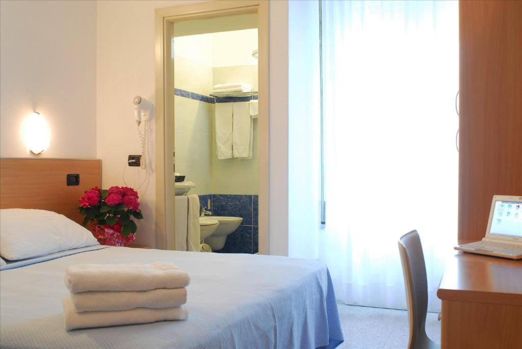 Postel nebo postele na pokoji v ubytování Hotel Veliero