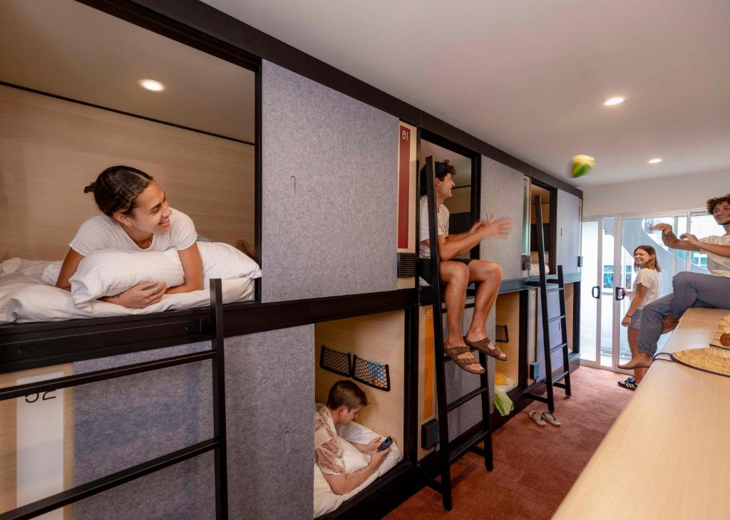 a group of people in bunk beds in a room at LyLo Brisbane in Brisbane