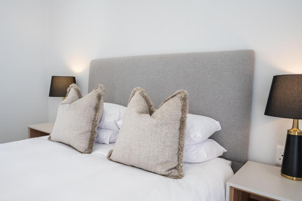 a bedroom with a white bed with two pillows at Atlantis Luxury Suites 3/4 in Swakopmund