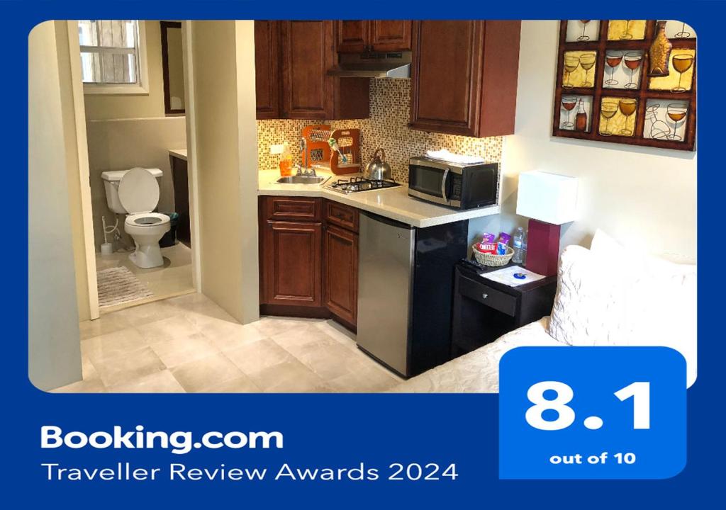 a small kitchen with a sink and a microwave at Island Retreat Studio #4 in Nassau