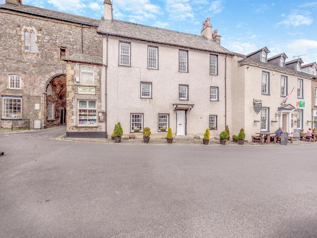 a large stone building with a street in front of it at Cartmel Place in Cartmel