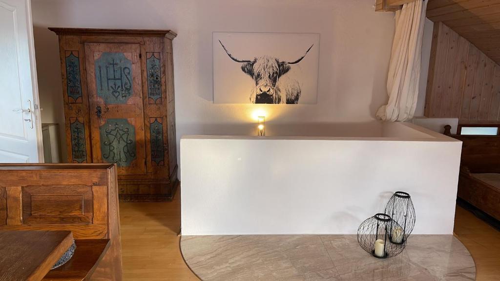 a white room with a picture of a bull on the wall at Alte Villa Traunstein in Traunstein
