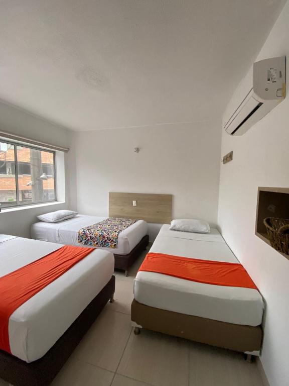 Postel nebo postele na pokoji v ubytování Suites Laureles