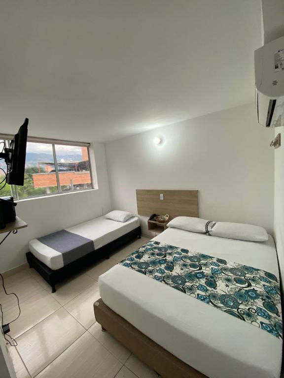 Postel nebo postele na pokoji v ubytování Suites Laureles