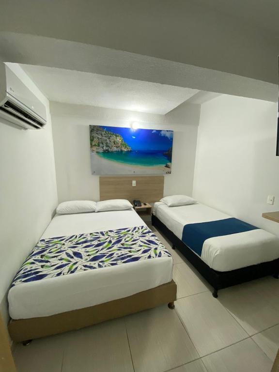 Postel nebo postele na pokoji v ubytování Suites Laureles