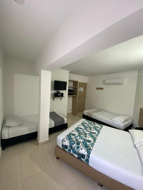 Postel nebo postele na pokoji v ubytování Suites Laureles
