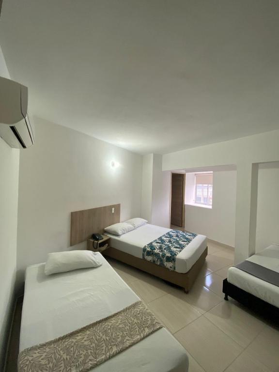Postel nebo postele na pokoji v ubytování Suites Laureles