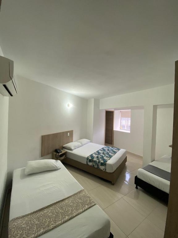 Postel nebo postele na pokoji v ubytování Suites Laureles