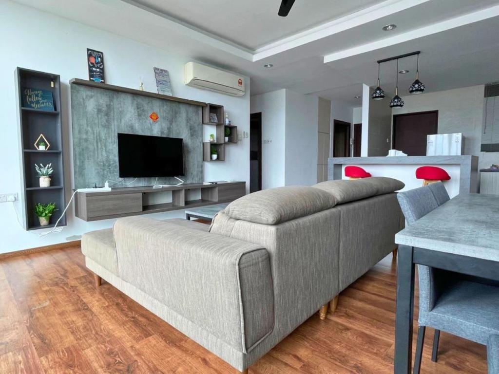 a living room with a couch and a television at DS VivacityMall Jazz Suite 3 810 in Kuching