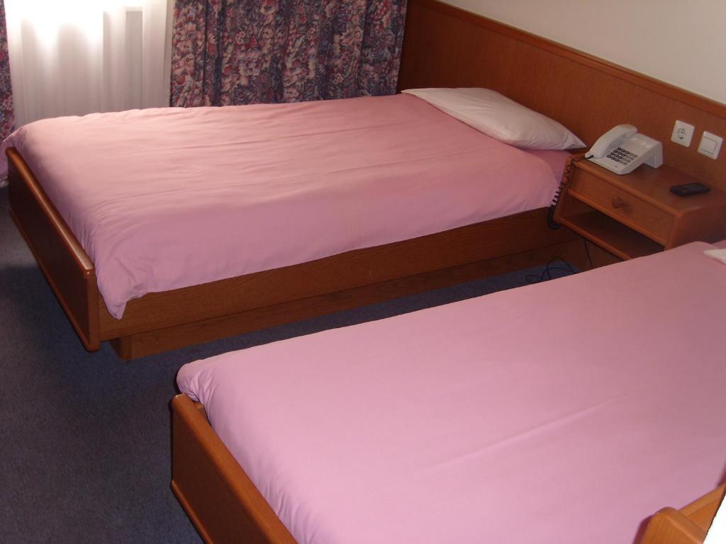 Postel nebo postele na pokoji v ubytování Hotel de Foetz