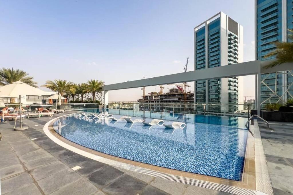 a swimming pool on the roof of a building at Cozy studio, amazing amenities in Dubai
