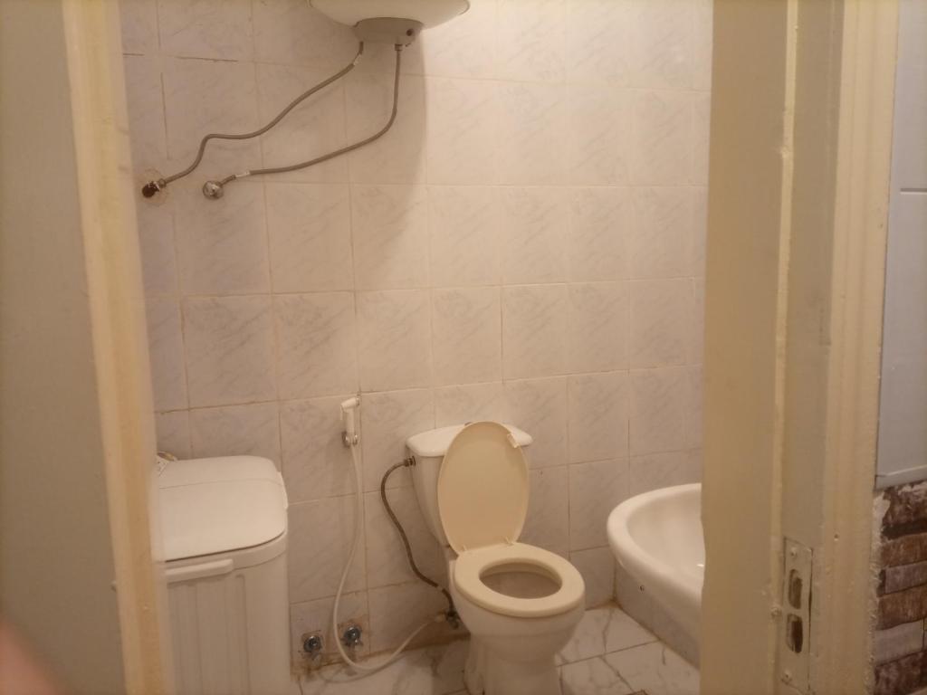 a small bathroom with a toilet and a sink at Andalius1 in Irbid