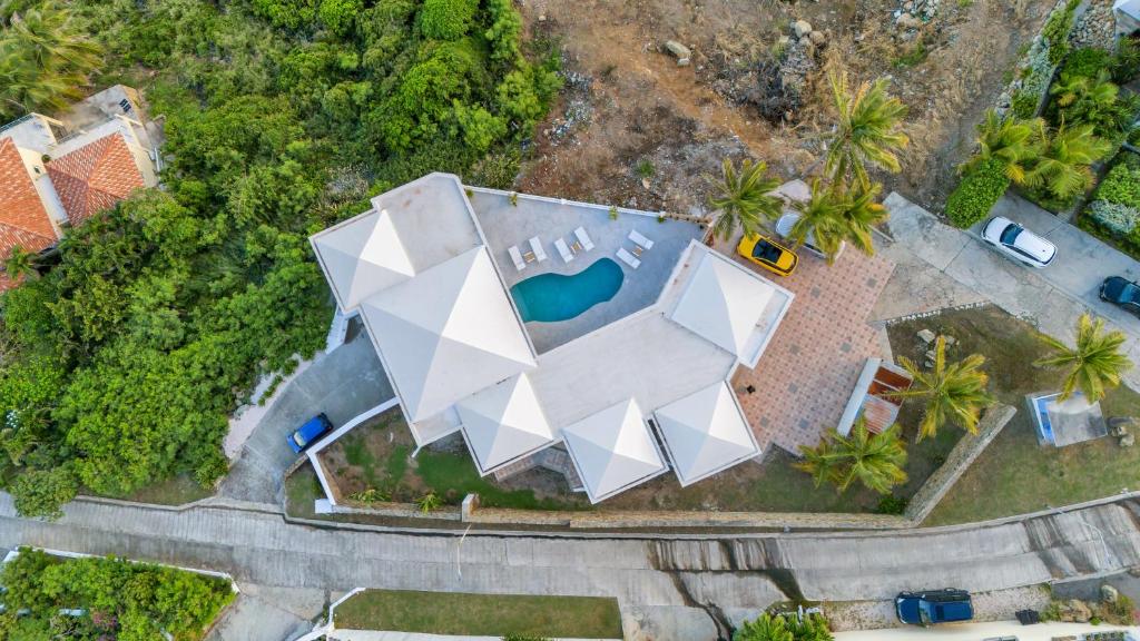 an aerial view of a white building with a pool at Oceanview Luxury Villa Escape in Dawn Beach
