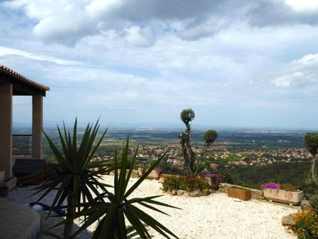 a view of a city from a house with plants at Villa Sorède, 4 pièces, 6 personnes - FR-1-776-11 in Sorède