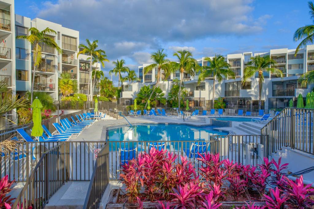 a resort pool with chairs and palm trees at 2BR in Key largo w pool and sunset views in Key Largo