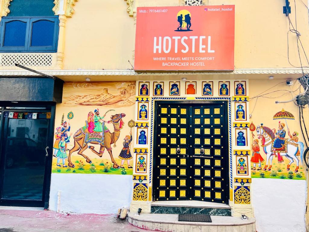 a building with a sign on the side of it at Hotstel Udaipur in Udaipur