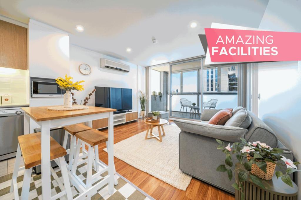 a kitchen and living room with a table and a couch at Wattle on Morphett - Central CBD WiFi in Adelaide
