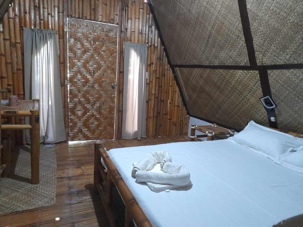 Postel nebo postele na pokoji v ubytování Na Wa Cottages