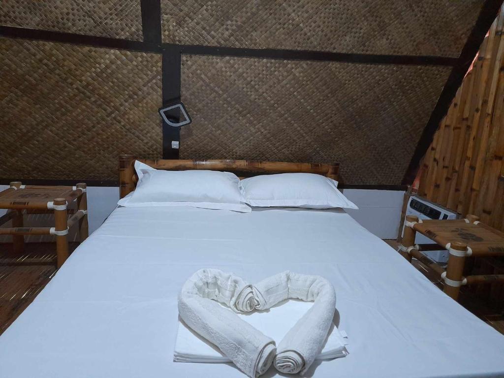 Postel nebo postele na pokoji v ubytování Na Wa Cottages
