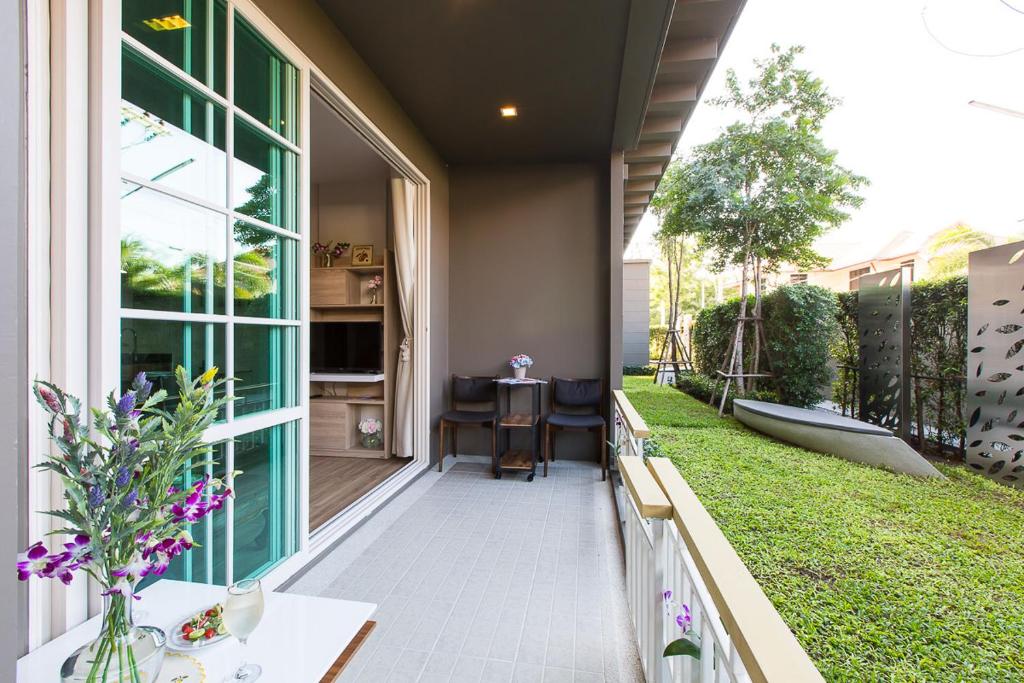 a balcony with a view of a yard at Autumn Condo in Hua Hin