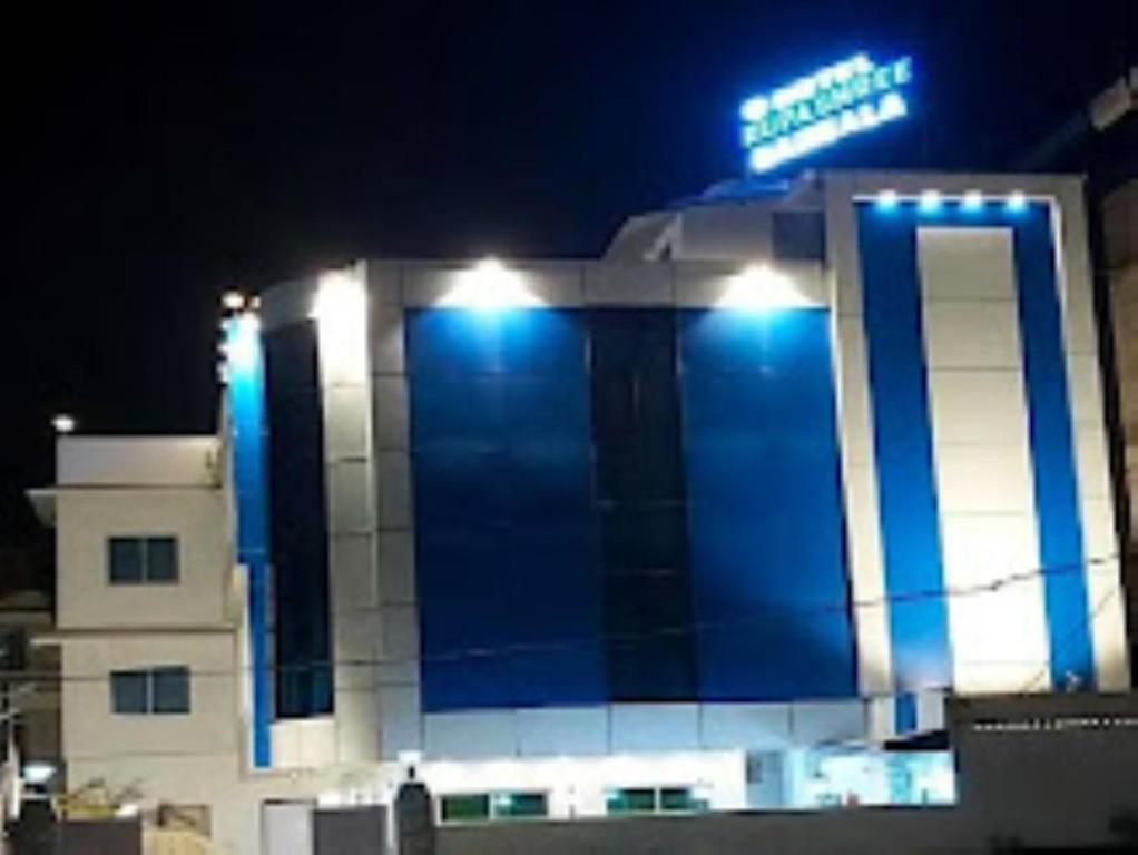een gebouw met 's nachts een bord erop bij Hotel Rupashree Bangala , Puri in Puri