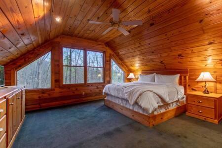 ein Schlafzimmer mit einem Bett in einer Holzhütte in der Unterkunft Family FUN-Relax-Mtn View-Game Rm-HotTub in Blue Ridge