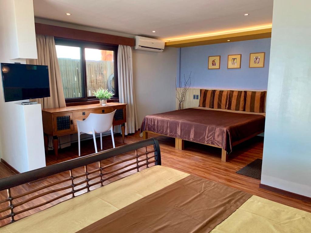 Postel nebo postele na pokoji v ubytování Boracay Beach Houses
