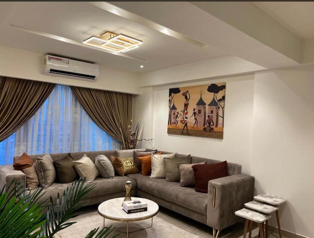 a living room with a couch and a table at Executive One Bedroom Suite Space Available in Accra