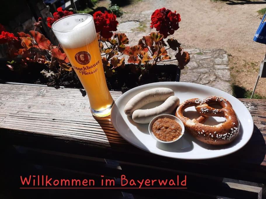 a plate of food with pretzels and a glass of beer at Musik und Natur - Balboo - Bayrischer Wald - Sauna - Pool - Grillen in Spiegelau
