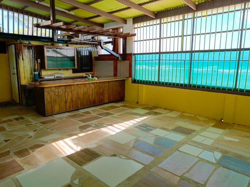 an empty room with a sink and a pool at Maburo sea breeze suites in Majuro