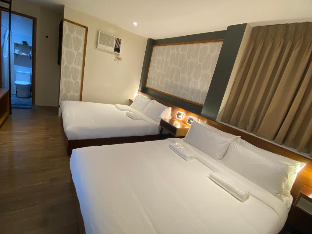 Postel nebo postele na pokoji v ubytování Jovinaj Travellers Inn