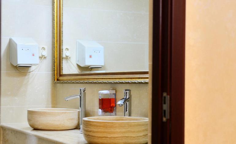 a bathroom with a wooden sink and a mirror at Pensiunea Junior in Cluj-Napoca