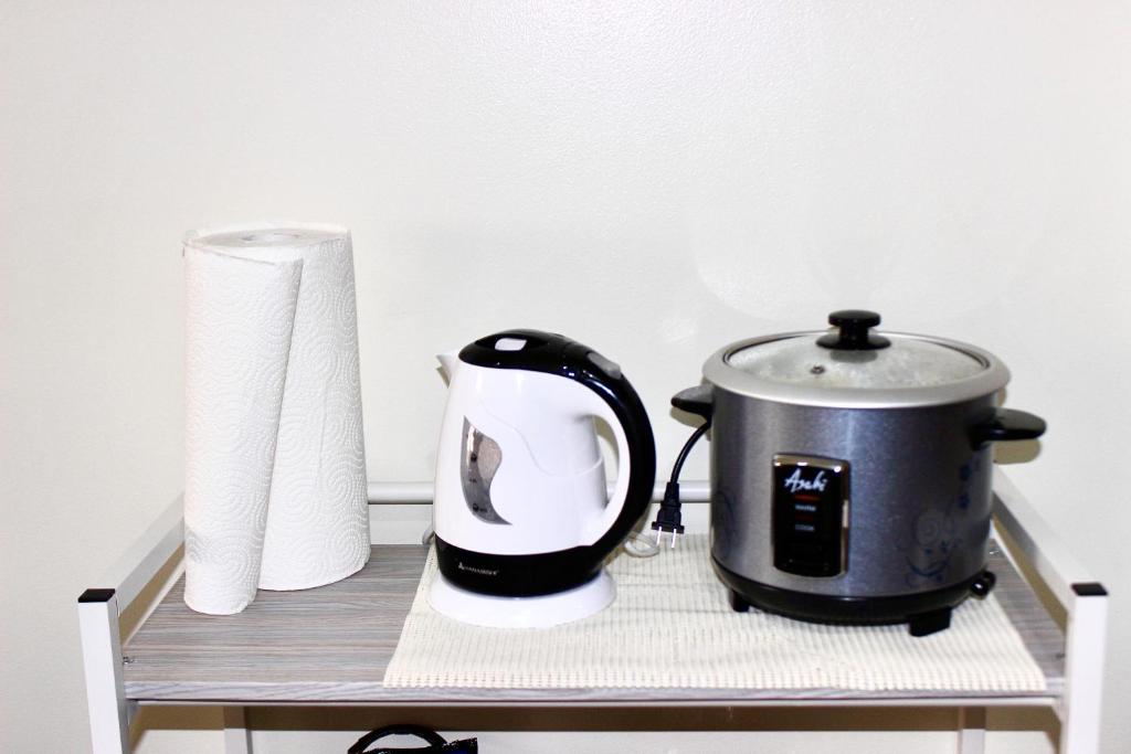 a toaster and a roll of toilet paper on a shelf at La Vida Hermosa in Manila