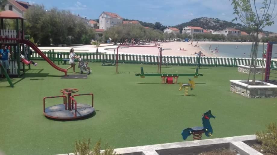 a park with a playground with a horse and a slide at Apartmani Betina - Petra Preradovića 2K in Betina