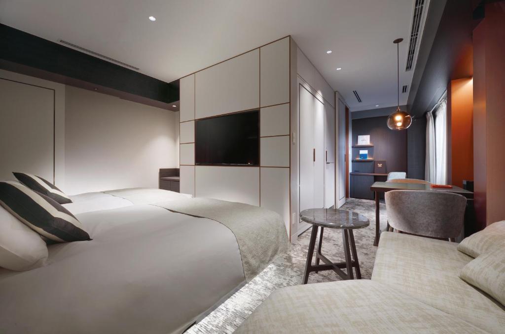 Postel nebo postele na pokoji v ubytování Nagoya Kanko Hotel