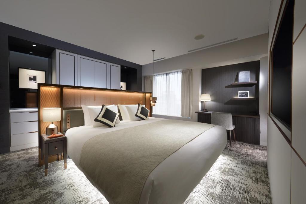 Postel nebo postele na pokoji v ubytování Nagoya Kanko Hotel