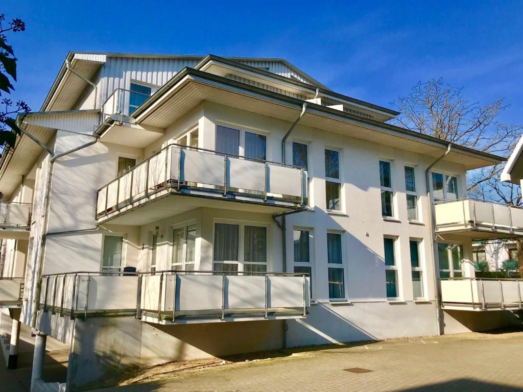 a white building with balconies on the side of it at Villa Maria 10 in Binz