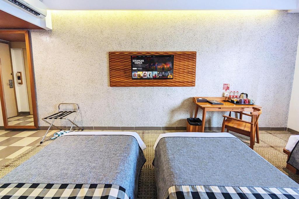 Postel nebo postele na pokoji v ubytování THE 1O1 Bandung Dago