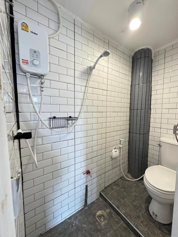 uma casa de banho com um chuveiro e um WC. em Chubby 9 Room 7 em Banguecoque