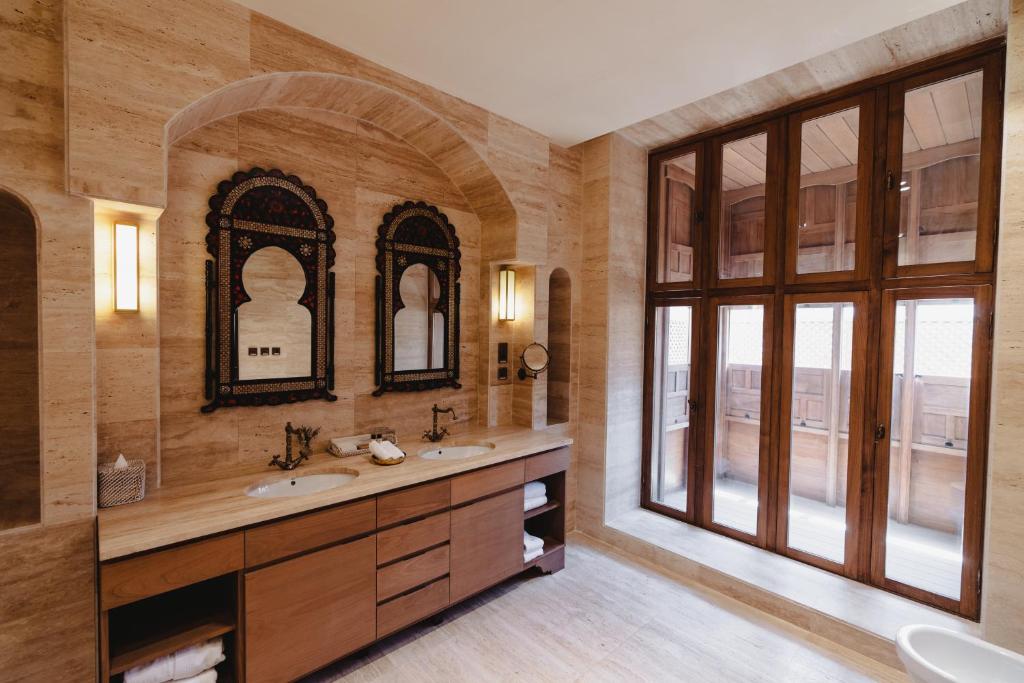 a bathroom with two sinks and a large window at Al Balad Hospitality in Jeddah