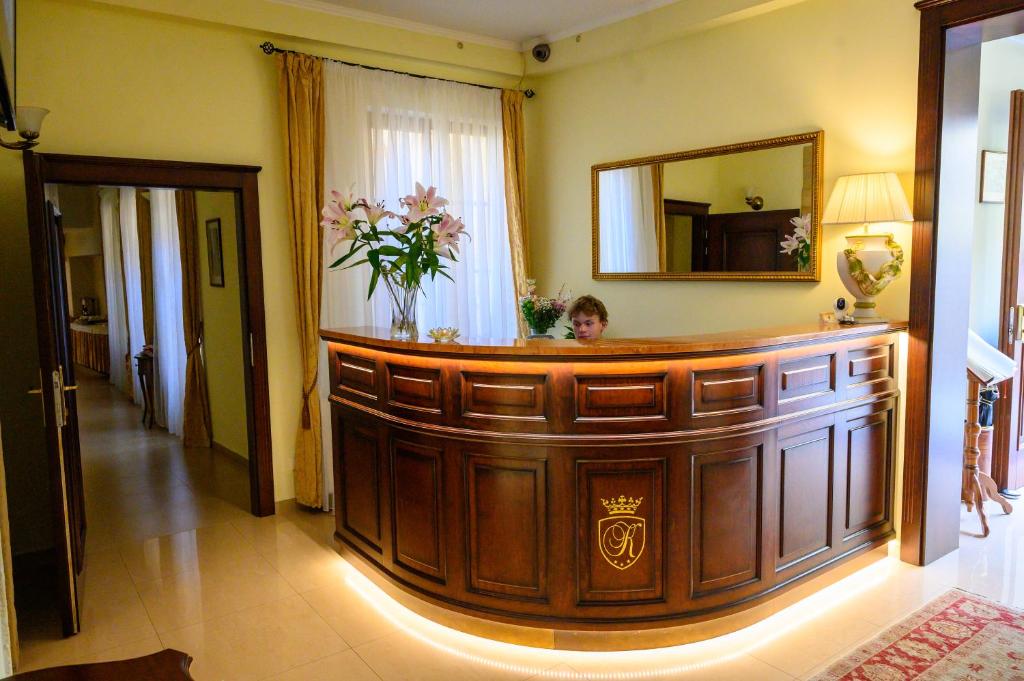 a person sitting in a room with a large wooden lobby at Hotel U Krále in Jičín