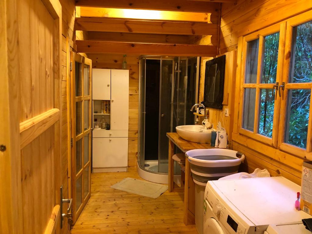 a bathroom with a toilet and a sink and a shower at Maison Bois in Laruns