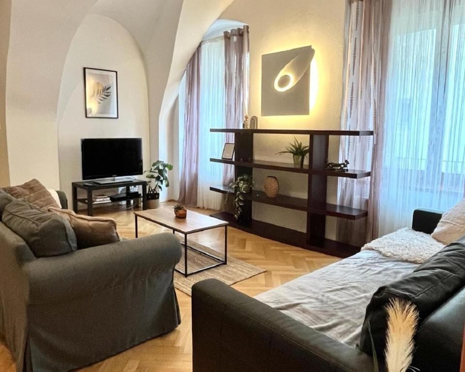 a living room with a couch and a tv at Apartment Sophie - Old Town in Bratislava