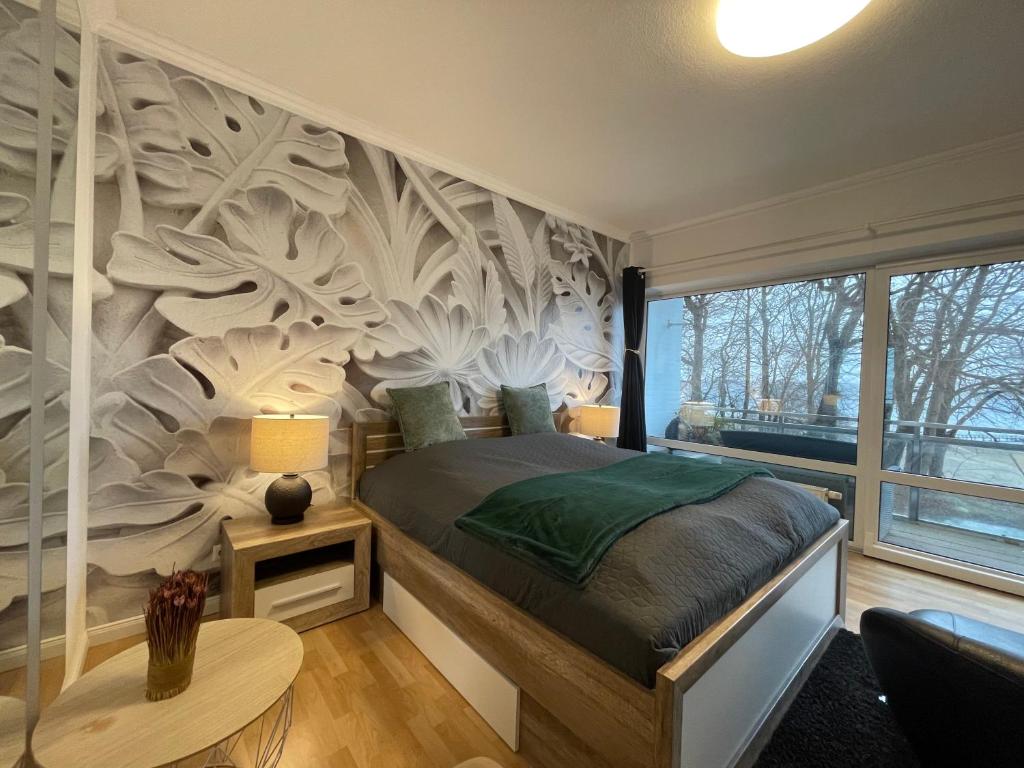 a bedroom with a bed with a wall mural at Flensburg Solitüde in Flensburg