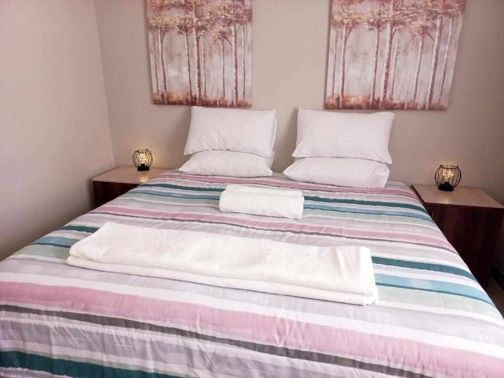 a bedroom with a bed with two towels on it at TALITHA'S SELF-CATERING ACCOMMODATION in Walvis Bay