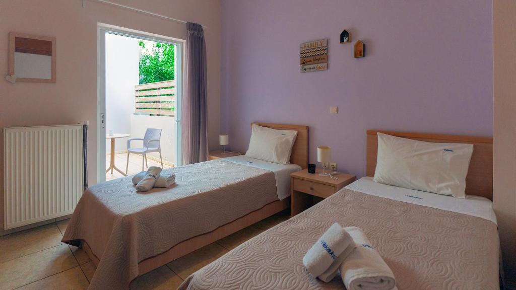 Postel nebo postele na pokoji v ubytování Vakakis-ME Apartments